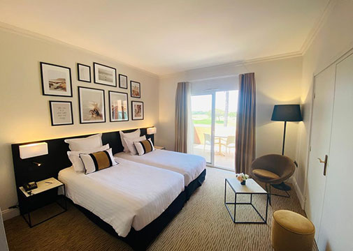Vista de la habitación Junior Suite del Palmyra Golf, hotel de 4 estrellas en Cap d’Agde, con sofá cama y terraza privada
